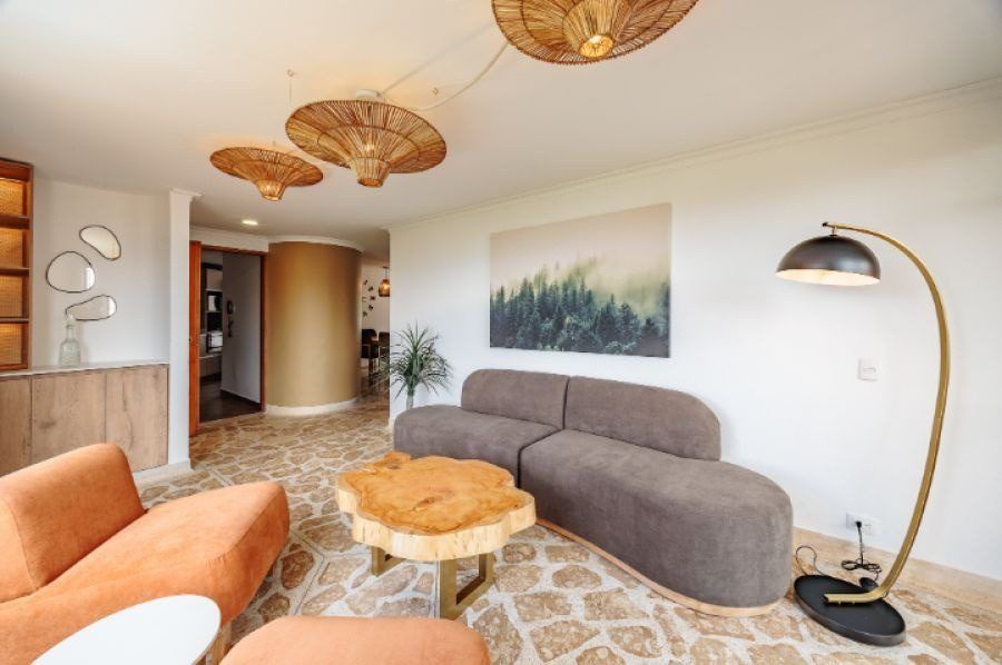 Living area with orange sofa and wood table at Balcony apartment, Medellin