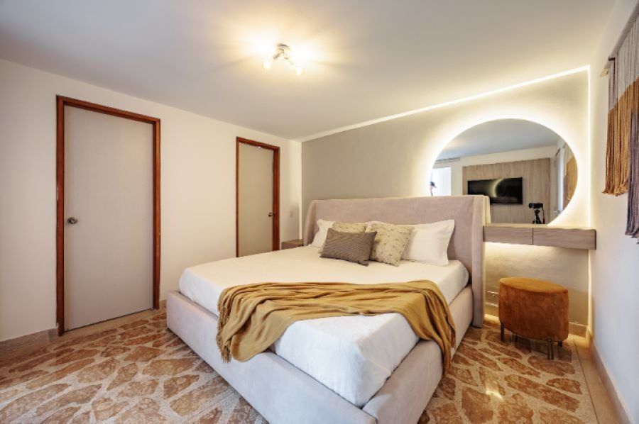 Bedroom with round mirror at Balcony apartment, Medellin
