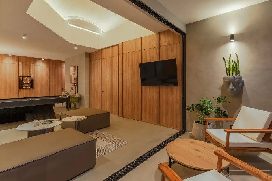 Lounge area with wood paneling and armchairs at Balcony apartment, Medellin