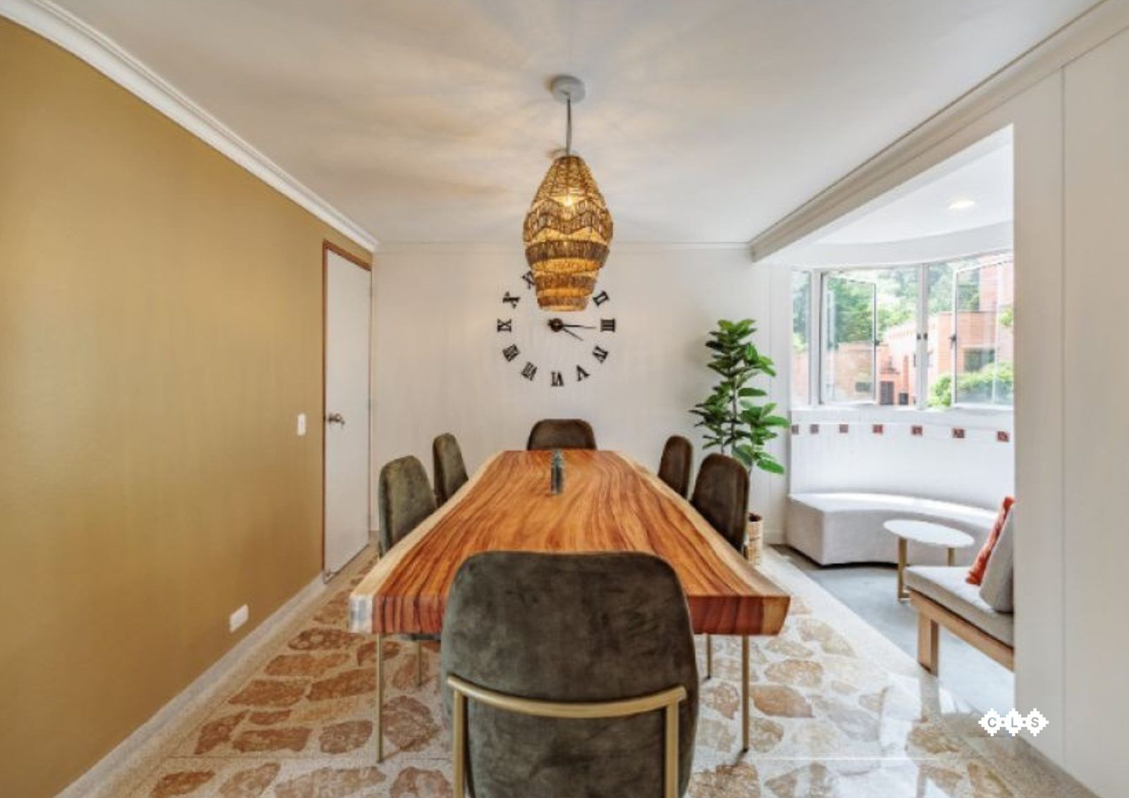 Dining room with wooden table and gold chandelier at Balcony apartment, Medellin