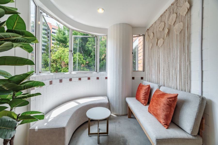 Curved window seating nook at Balcony apartment, Medellin