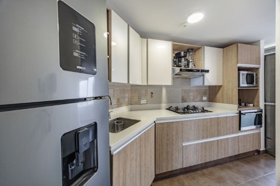 Kitchen with refrigerator and stove at Balcony apartment, Medellin
