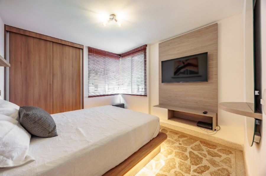 Bedroom with TV and wood closet at Balcony apartment, Medellin
