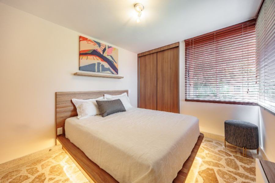 Bedroom with warm lighting at Balcony apartment, Medellin