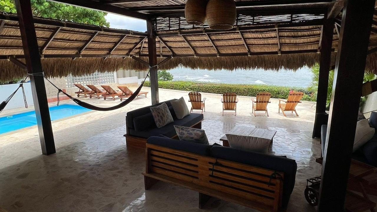 Shaded kiosk with hammock and pool view at House Playa, Cartagena