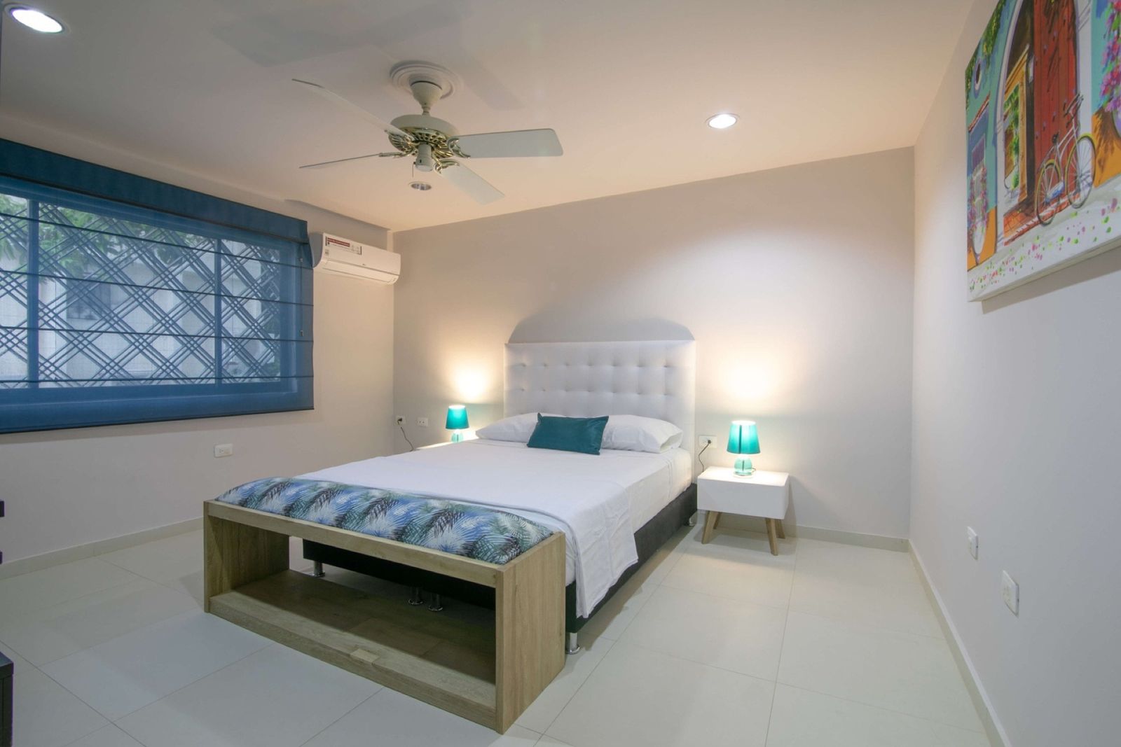 Bedroom with colorful Cartagena painting at Mar House
