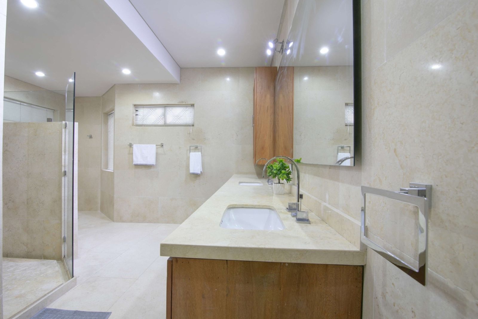 Bathroom with walk-in shower and wood vanity at Mar House