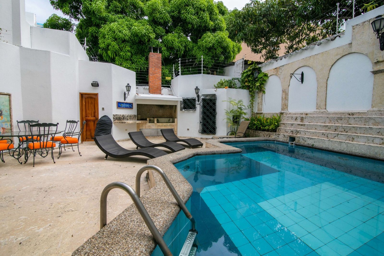 Pool deck with loungers and outdoor dining at Mar House, Cartagena