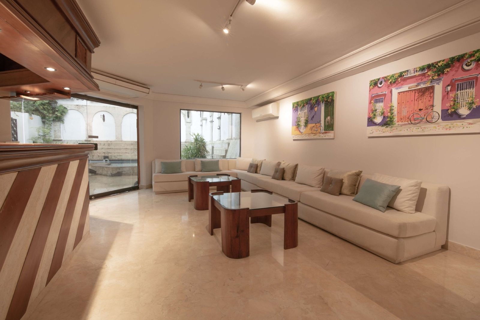 Living room with large sectional sofa and Cartagena artwork at Mar House