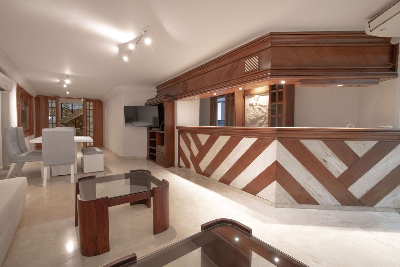 Wood and marble bar with lounge area at Mar House, Cartagena