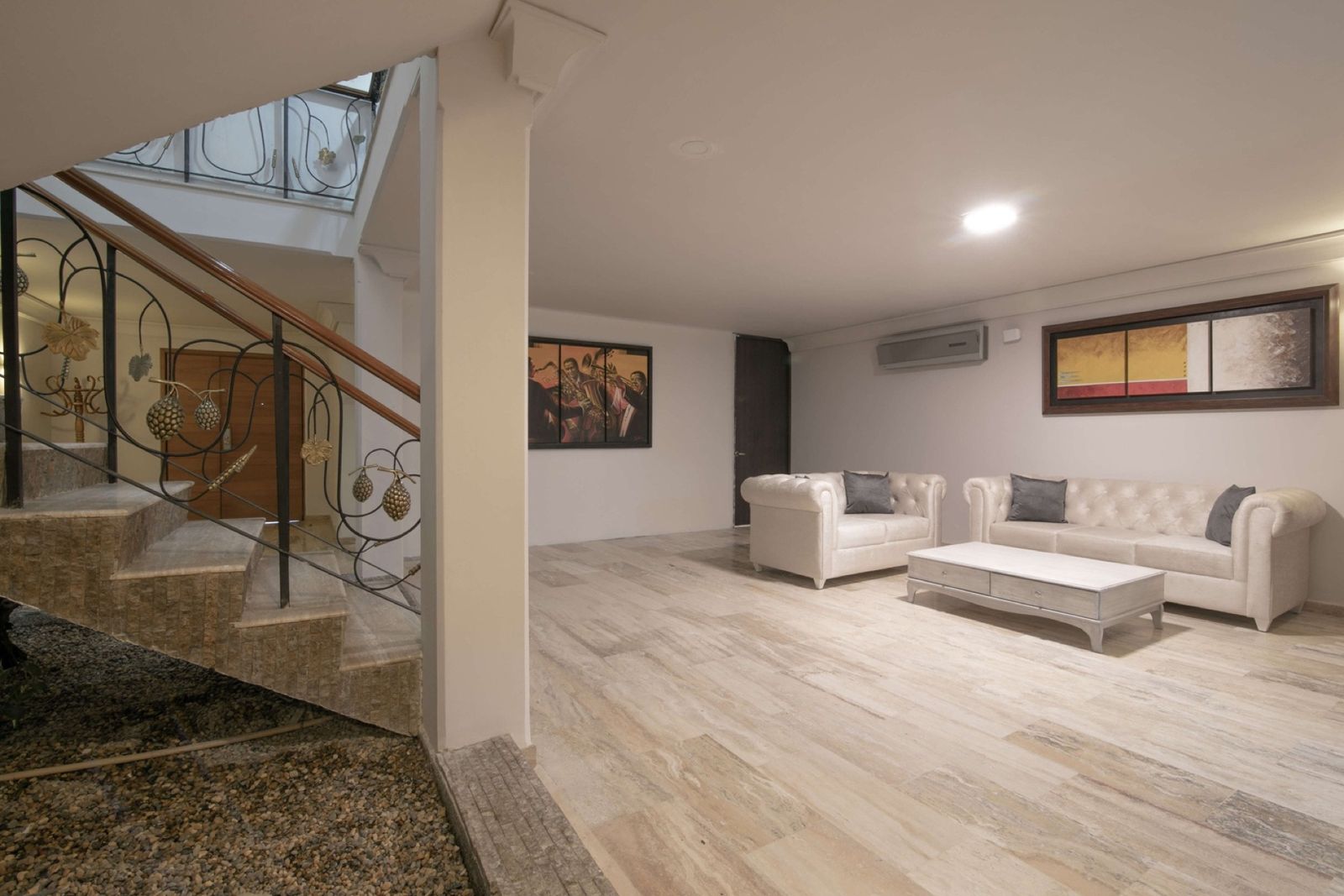 Second living room with white sofas beside the staircase at Mar House