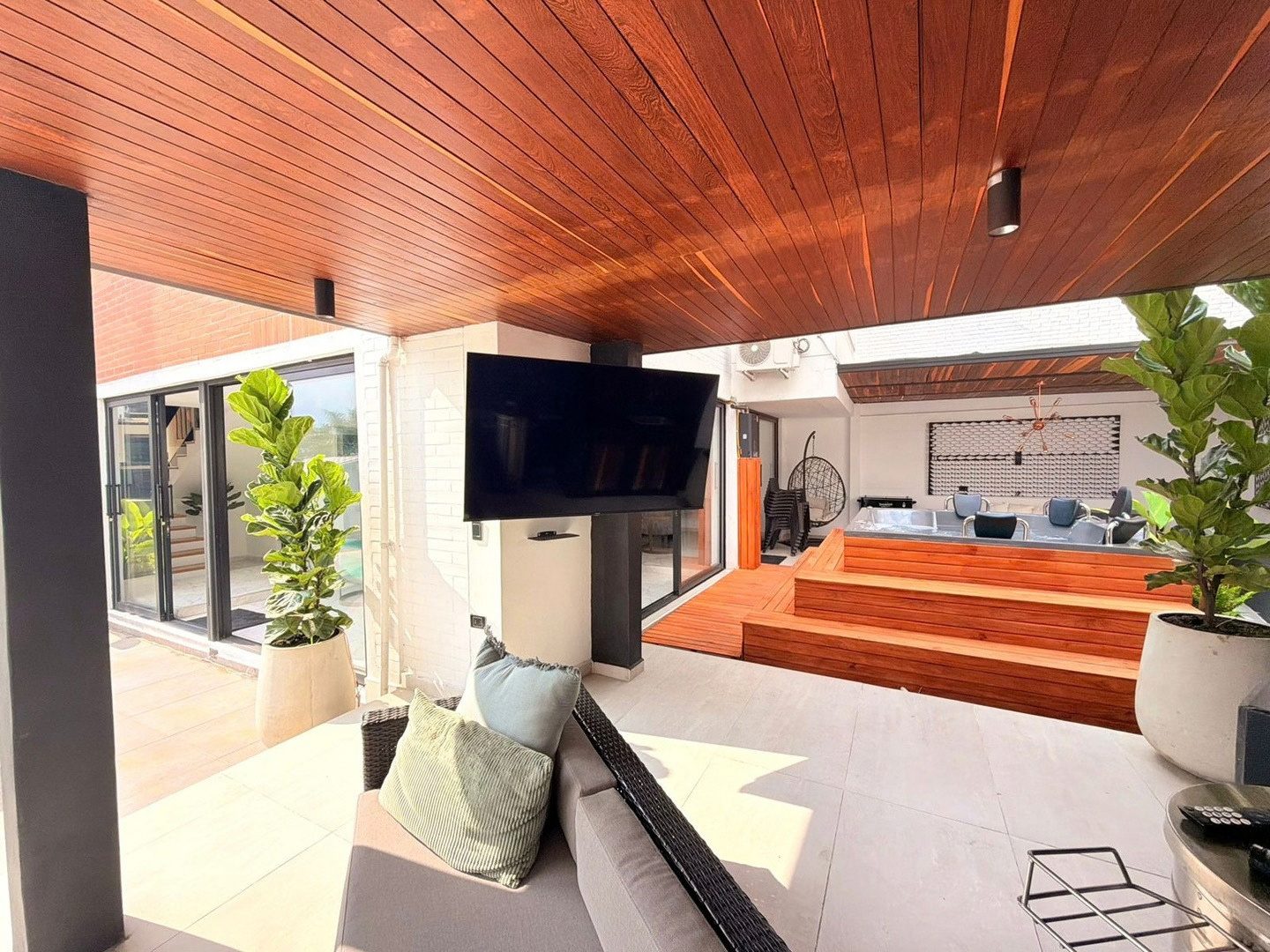 Social terrace with TV and wood ceiling at Pool House