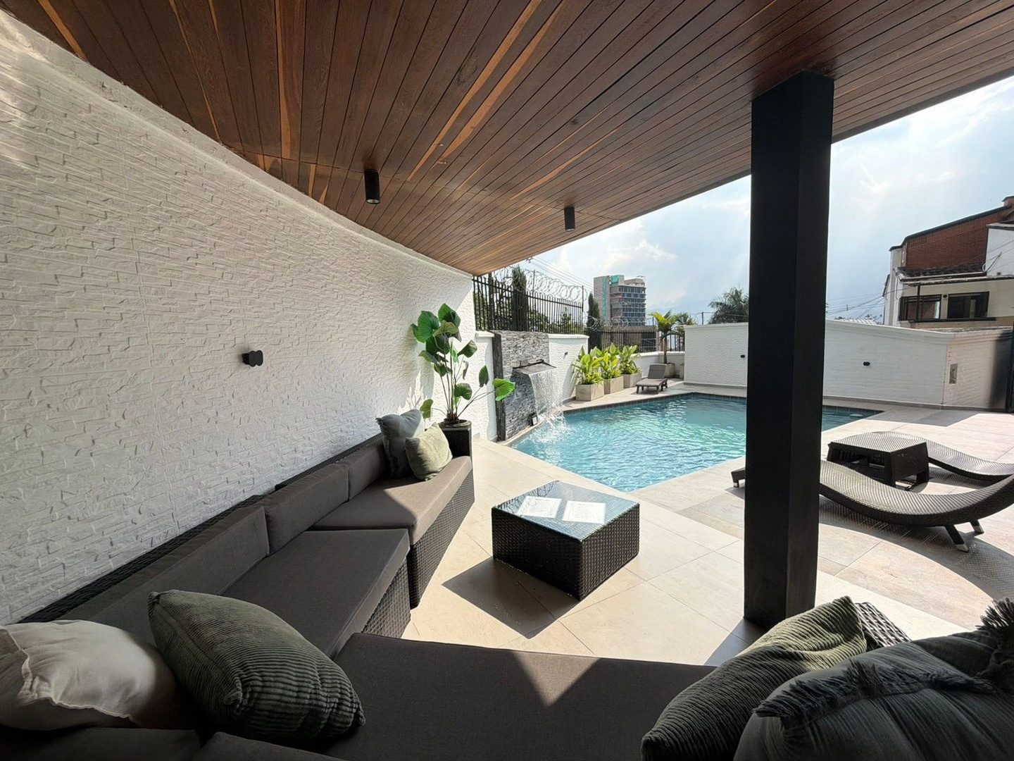 Covered lounge facing the pool at Pool House
