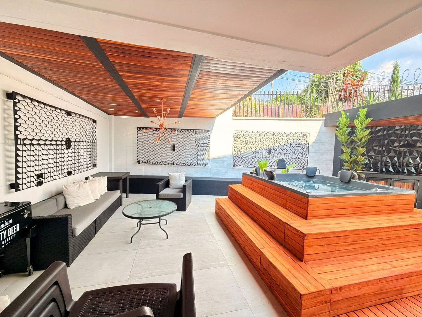 Raised deck with jacuzzi and outdoor lounge at Pool House