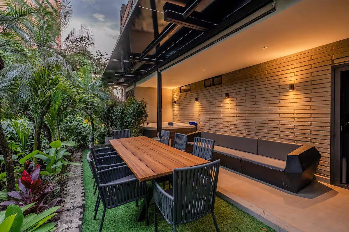 Garden patio with outdoor dining and lounge at Provenza 3 villa, Medellin