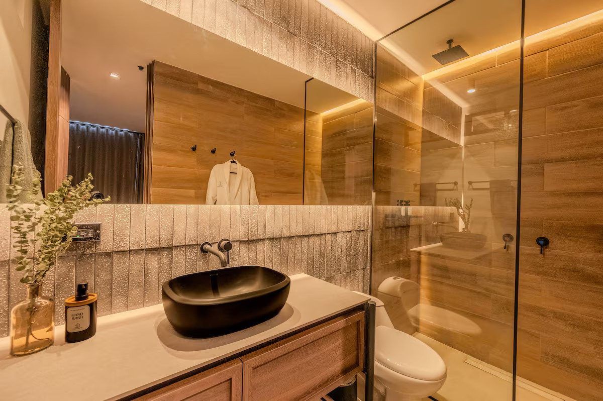 Bathroom with black basin and glass shower at Provenza 3, Medellin