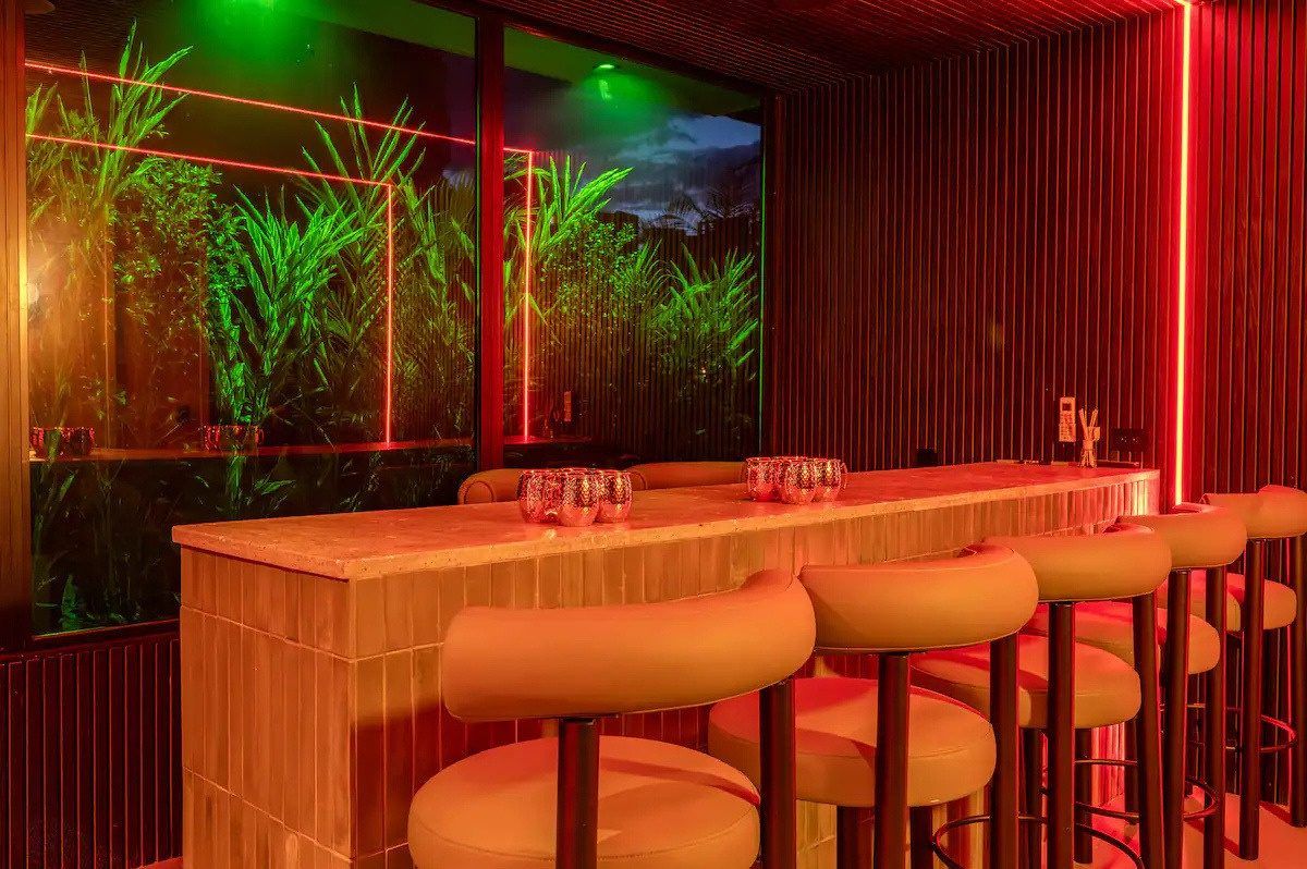 Private nightclub bar lit in red at Provenza 3 villa, Medellin