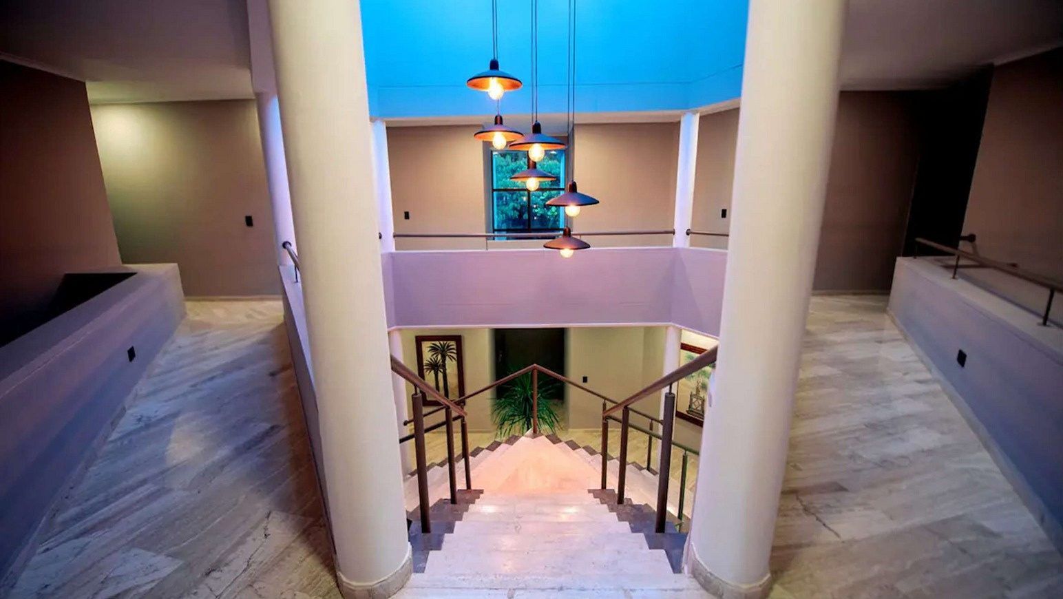 Entrance atrium with columns, staircase and skylight at White Mansion, Medellin