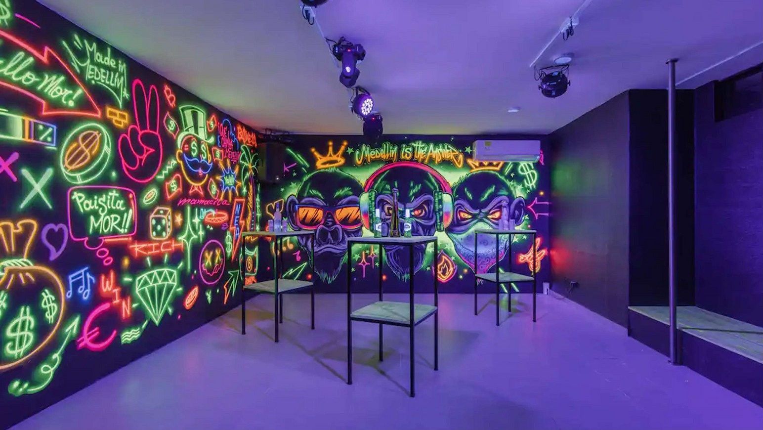 Neon-mural lounge area at White Mansion, Medellin