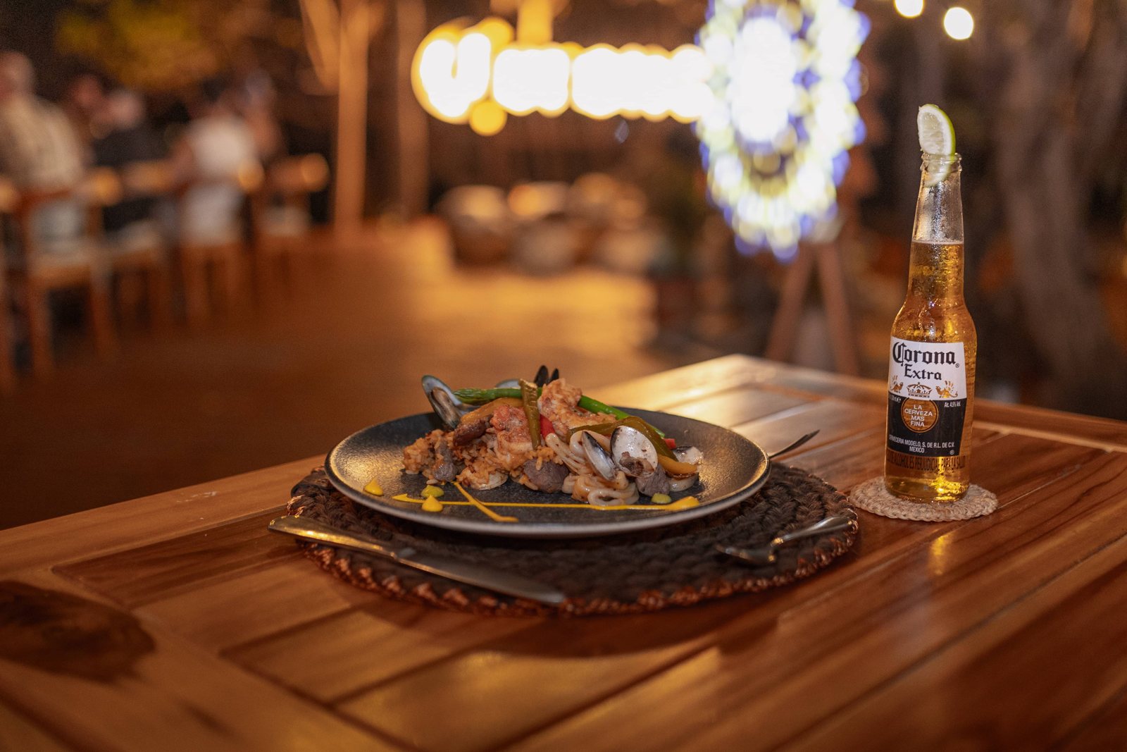Seafood dish and a Corona beer on a wooden table at Corona Island, Rosario Islands