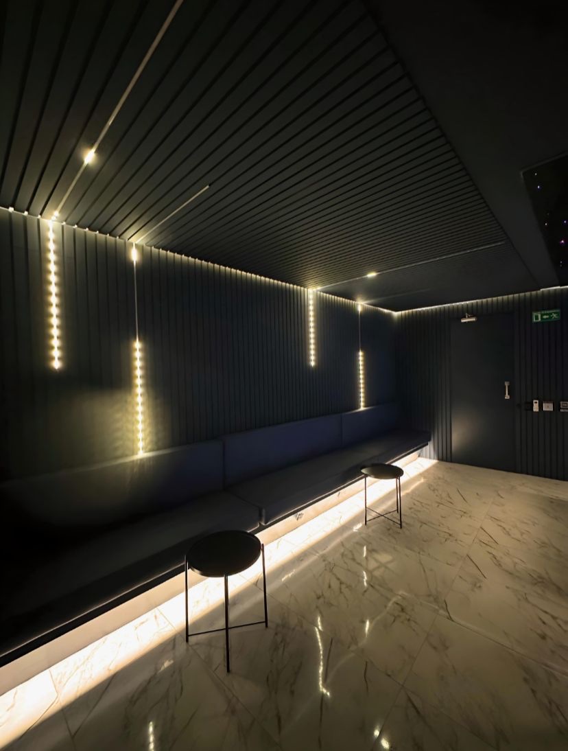 Blue Room in Medellín: glass-block DJ booth under a large screen and a starry ceiling